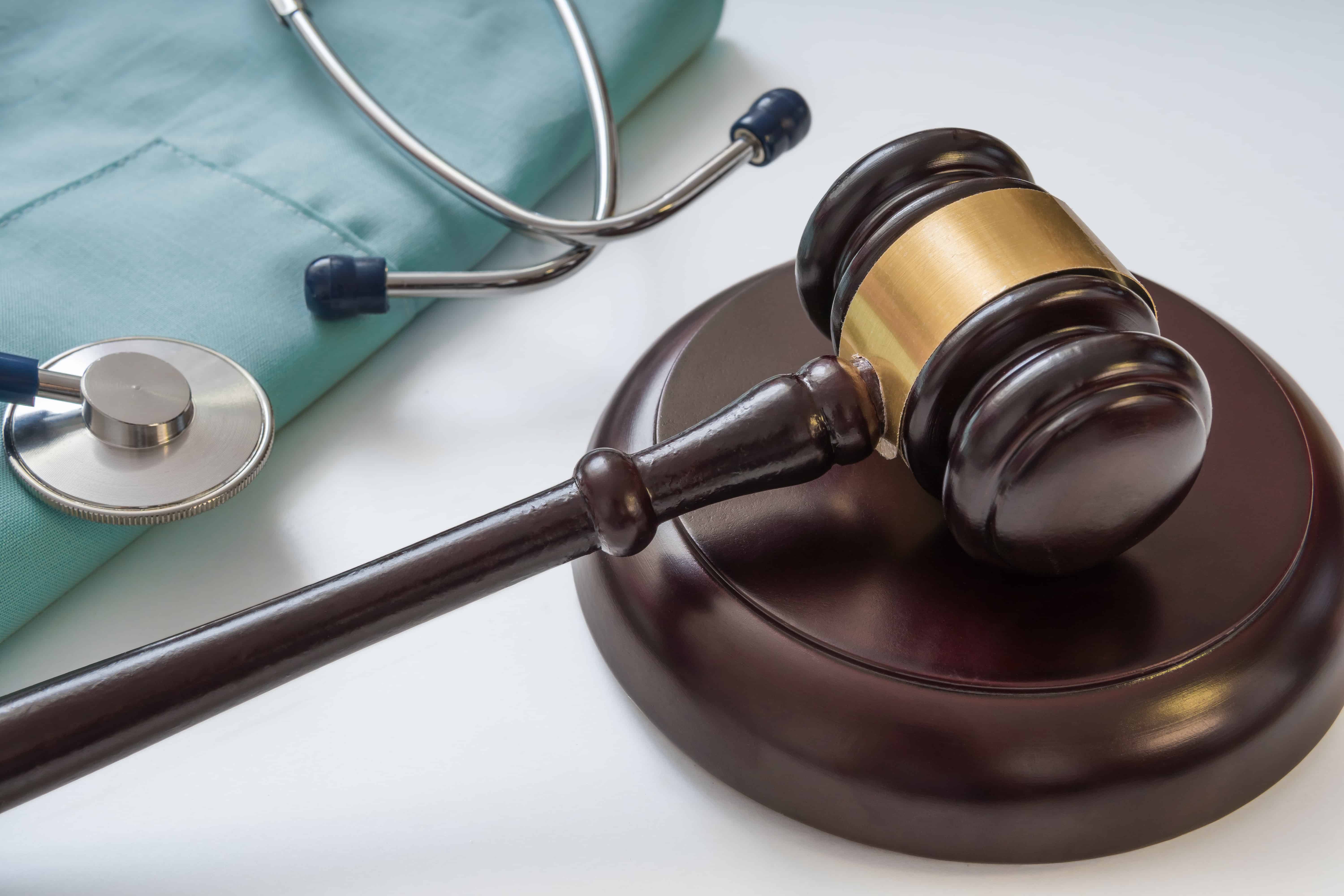 Gavel and stethoscope in background. Medical laws and legal concept. | ABD